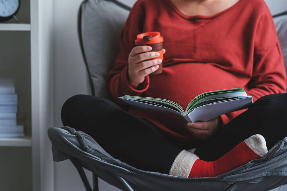 pregnant woman sitting and reading