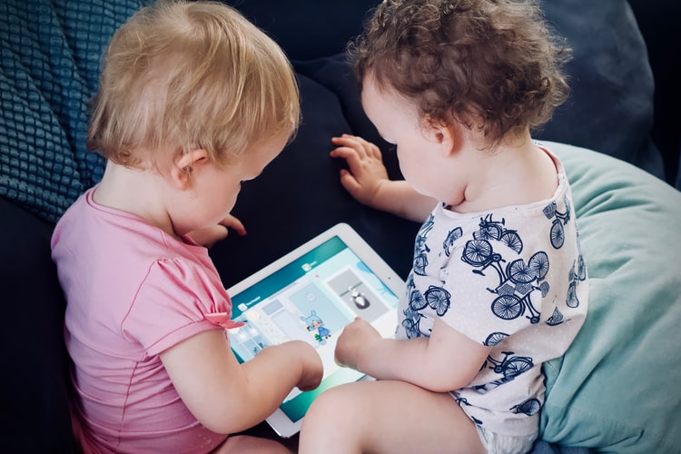 two surrogate children with tablet
