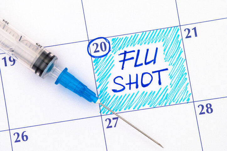 Image of a calendar with a flu shot reminder.