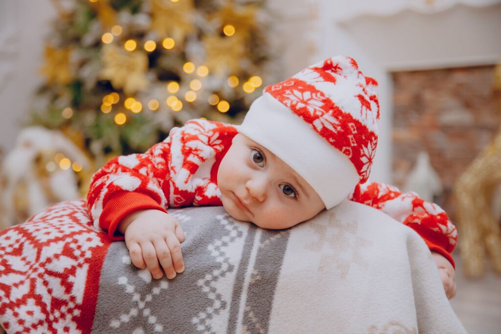 Cute baby dressed in red and white, waiting for the parents
