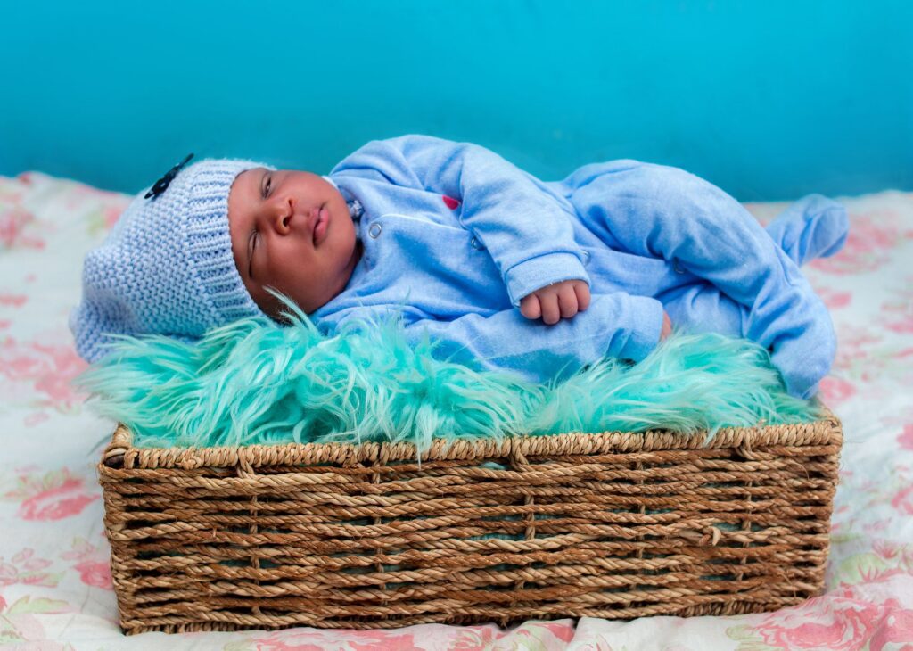 Cute baby lying on a woven basket